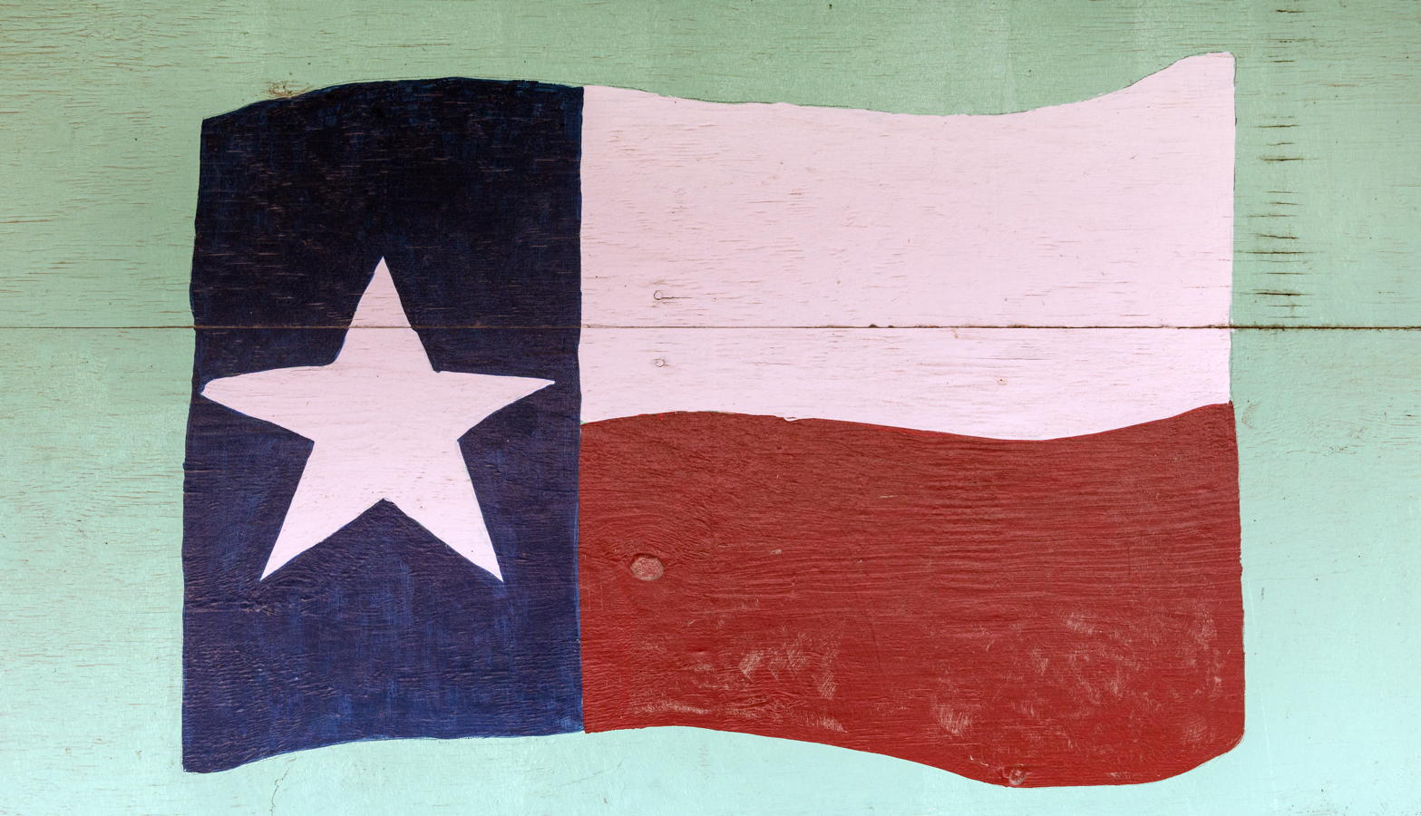 Texas flag on a Pecos wall