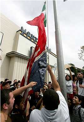 Montebello High School Flag: Students at Montebello High School raise the Mexican flag above an inverted American flag.; Los Angeles, California; American flag