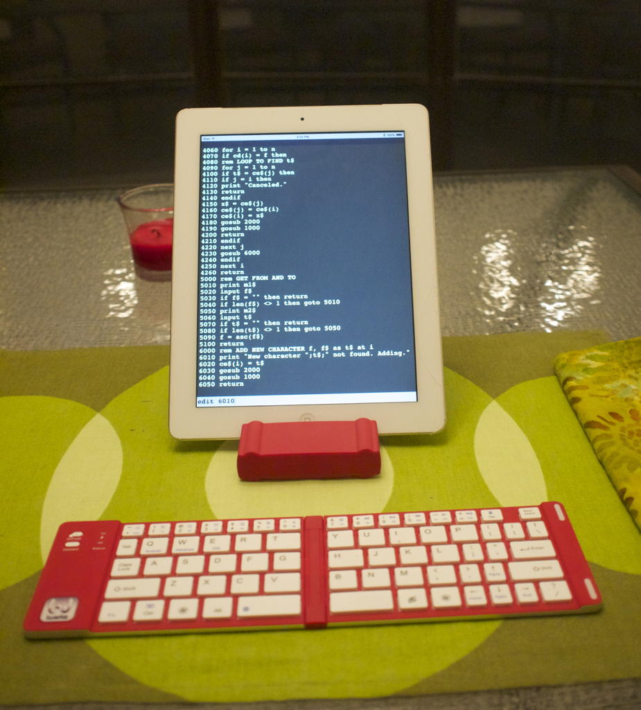 iwerkz portable keyboard and iPad : The iwerkz portable folding keyboard and an iPad standing in the keyboard’s dual-use case.; iPad; Bluetooth; keyboards