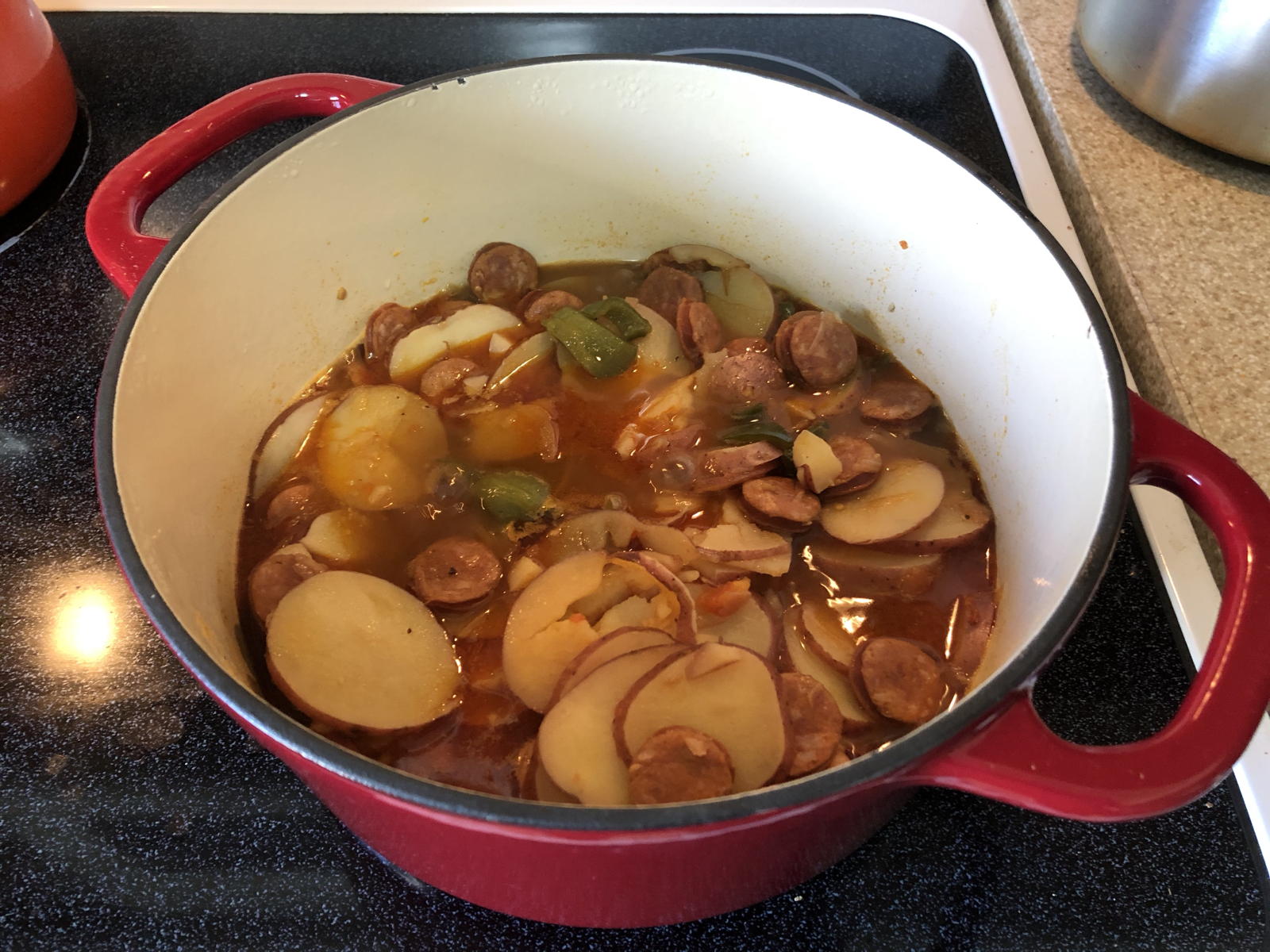 Potato Paprika Stew in a pot: Making Paprikás Burgonya in a Dutch oven.; Hungary; soups and stews; potatoes; paprika