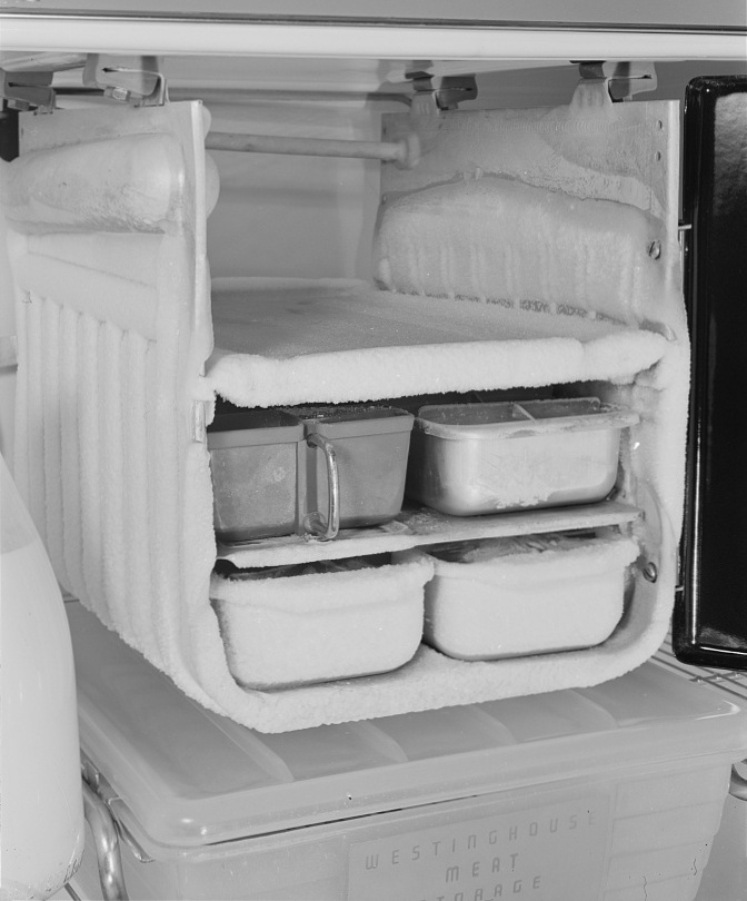 Iced-over freezer compartment: Conservation of durable goods: Old Man Winter comes to the refrigerator. This unfortunate freezing compartment is lumbering along day and night, coated with excess frost. Defrost frequently, keep the cold control set at ‘low’ except when freezing ice cream or ice cubes, and keep the frost formation below ¼ inch thick to assure best…”—Rosener, Ann, photographer, 1942; ice; refrigerators