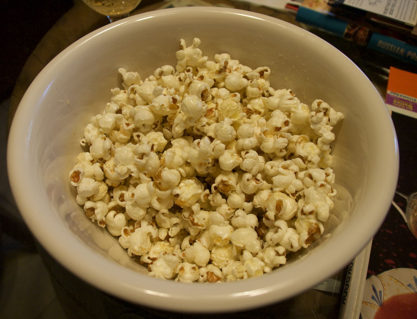Buttered popcorn: Buttered, salted popcorn in a bowl.; popcorn; butter