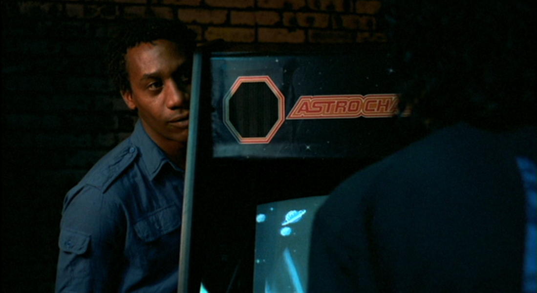 Speeding up Astro Chase: The Brother speeds up Astro Chase for a bored white girl.; arcade games