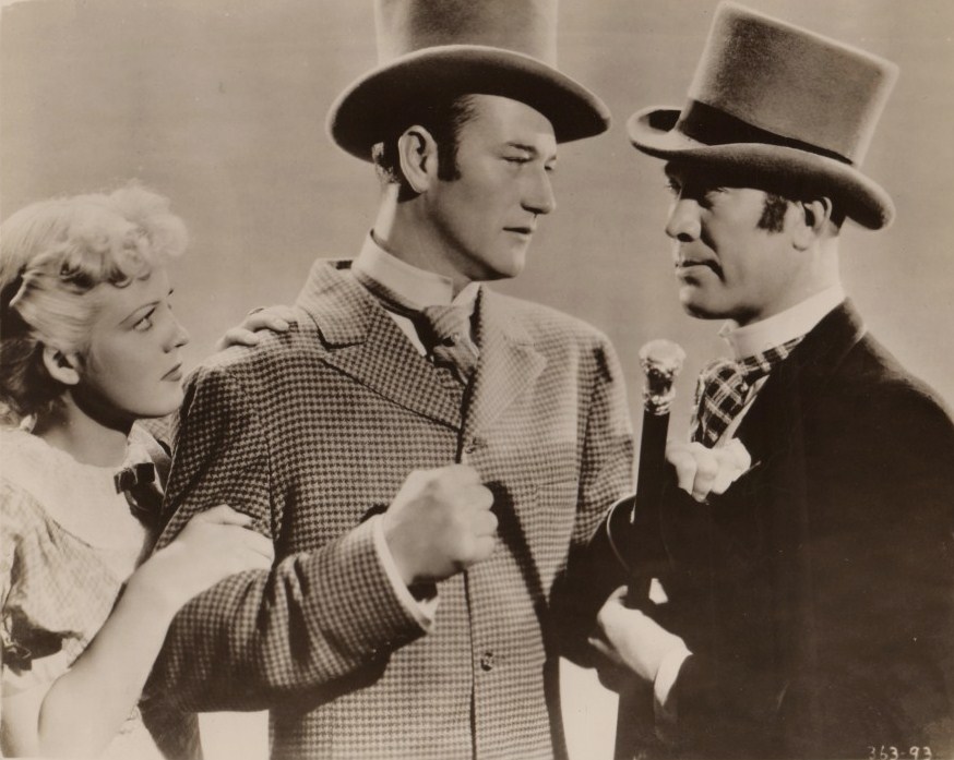 John Wayne in Conflict: Jean Rogers, John Wayne, and Ward Bond in a publicity still for the Universal movie Conflict.; John Wayne