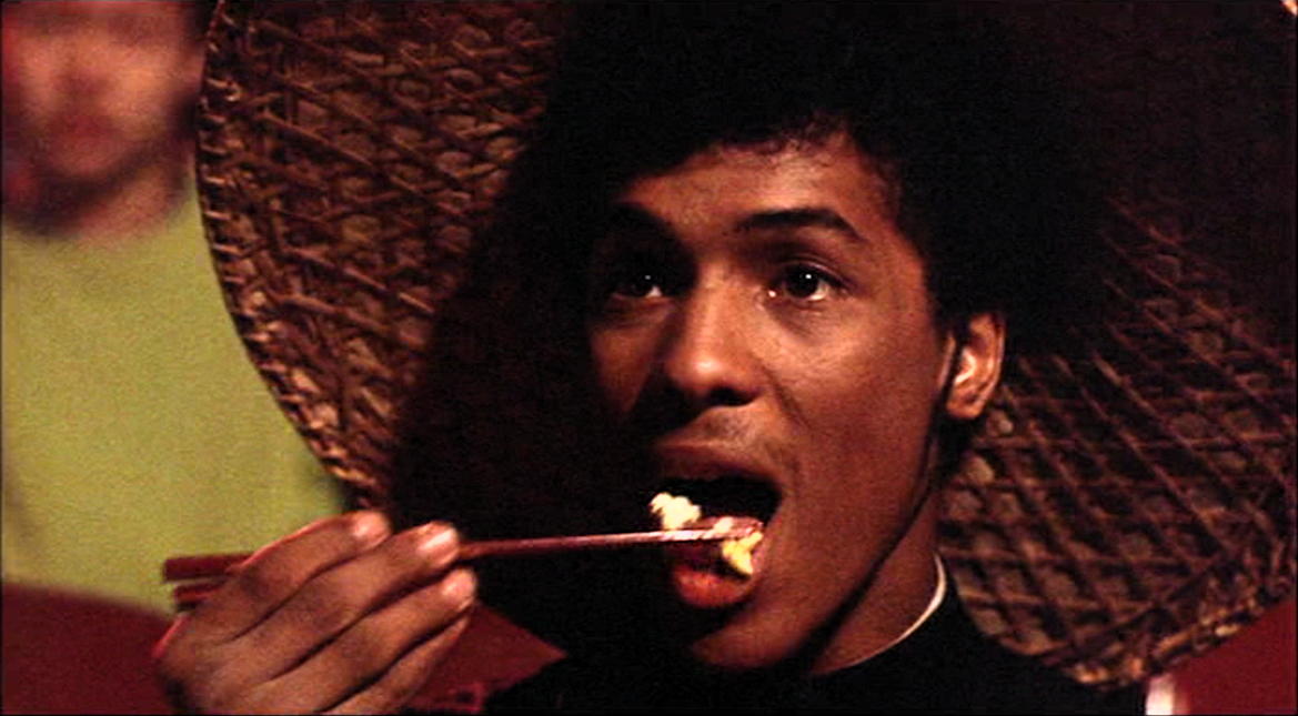 Chopstick Popcorn: “Bruce Leroy” eating popcorn with a chopstick.; popcorn