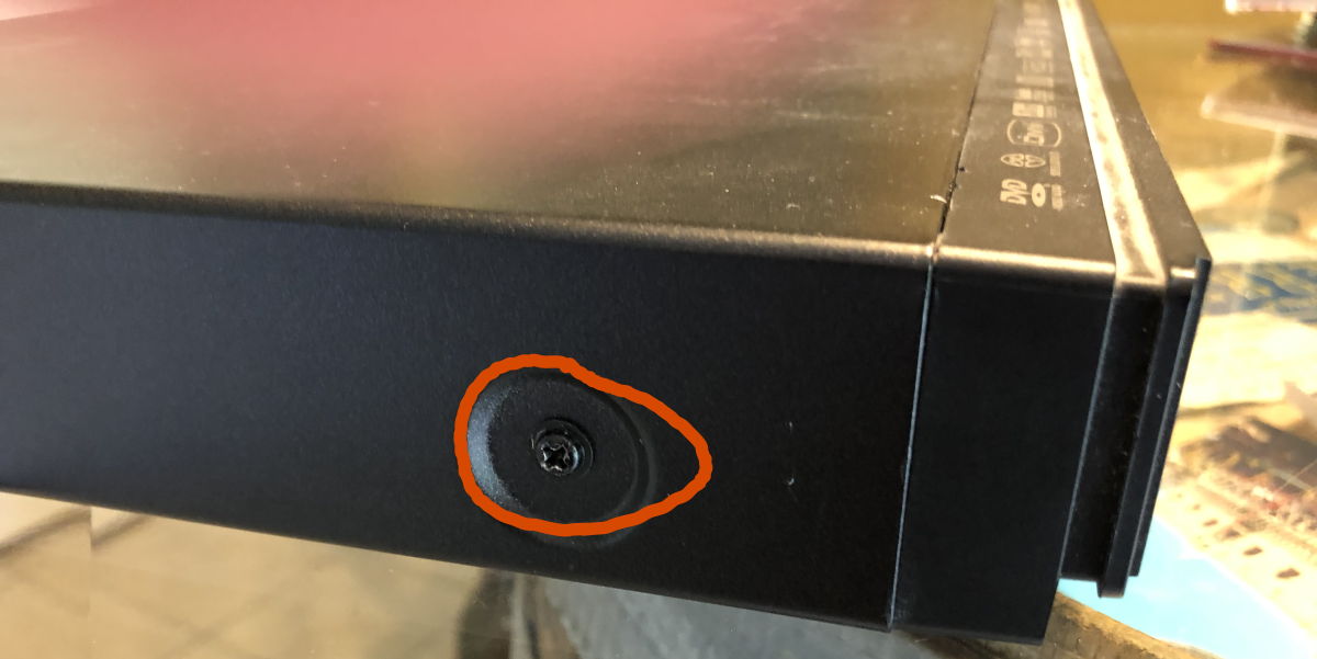 Oppo side screws: The side screws that need to be removed to remove the Oppo DVD player’s top.; OPPO DVD player