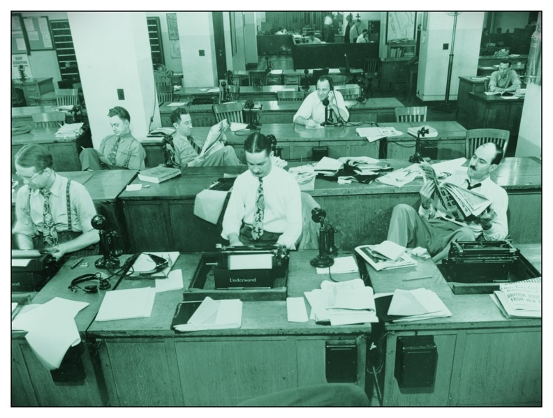 New York Times newsroom 1942: New York, New York. Newsroom of the New York Times newspaper. Reporters and rewrite men writing stories, and waiting to be sent out. Rewrite man in background gets the story on the phone from reporter outside.; journalism; New York Times