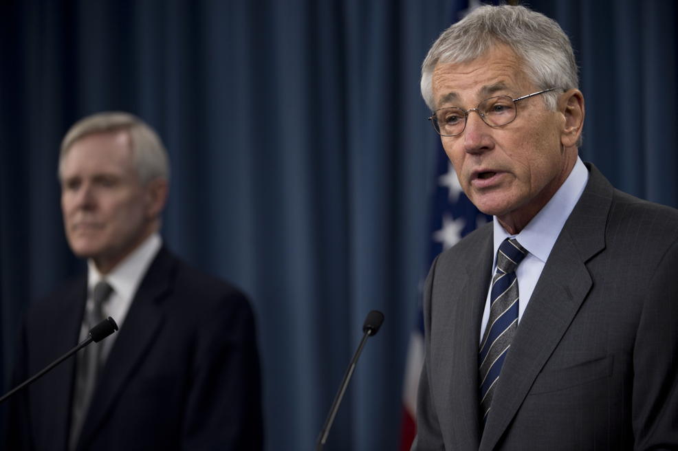 Defense Secretary Chuck Hagel Navy Yard remarks: “Defense Secretary Chuck Hagel delivers remarks as Navy Secretary Ray Mabus looks on during a briefing at the Pentagon, March 18, 2014. Hagel and Mabus addressed plans to implement security changes following the Sept. 16, 2013, shooting rampage at the Washington Navy Yard that left 12 employees dead and several others wounded.”; Department of Defense; DoD; Navy Yard shooting; Aaron Alexis; Chuck Hagel