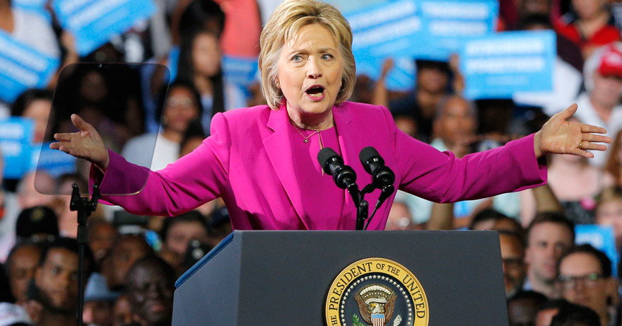 Hillary Clinton campaign speech at presidential podium: Democratic candidate for president 2016 speaks at a campaign speech at a podium bearing the presidential seal of the United States.; president; speech; Hillary Clinton