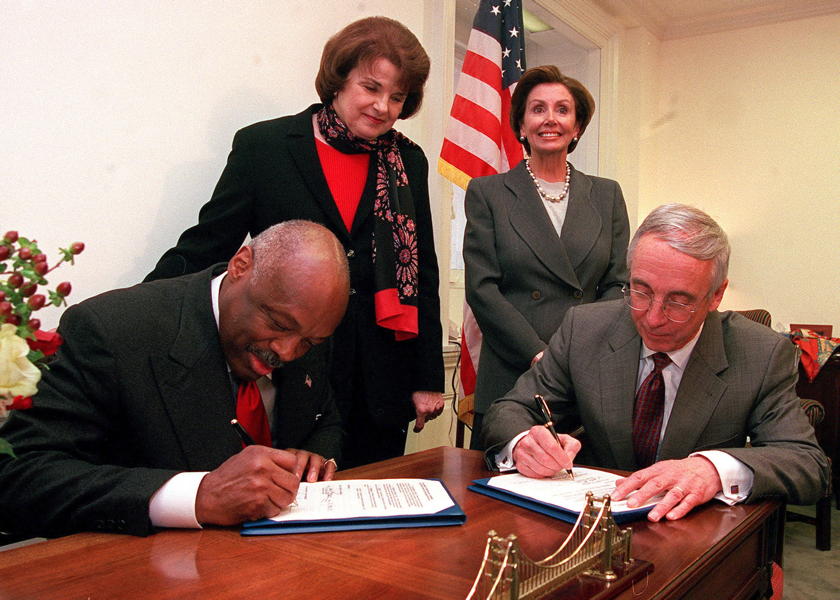 Navy returns Hunter’s Point: “Capitol Hill, Washington, D.C. (Jan. 23, 2002)—Secretary of the Navy the Honorable Gordon England (right), signs an agreement with San Francisco Mayor Willie Brown (left), transferring the former Hunter’s Point Naval Ship Yard to the city of San Francisco, CA, during a ceremony held in the office of Congresswoman Nancy Pelosi (D-Calif), (top right). Senator Dianne Feinstein (D-Calif), (top left) helped sponsor a bill to clean up Hunter’s Point before its transfer. The agreement allows the city to develop parcels of ready land, while clean up of the facility continues. U.S. Navy photo by Chief Photographer’s Mate Dolores L. Parlato.”; Dianne Feinstein; San Francisco; Nancy Pelosi