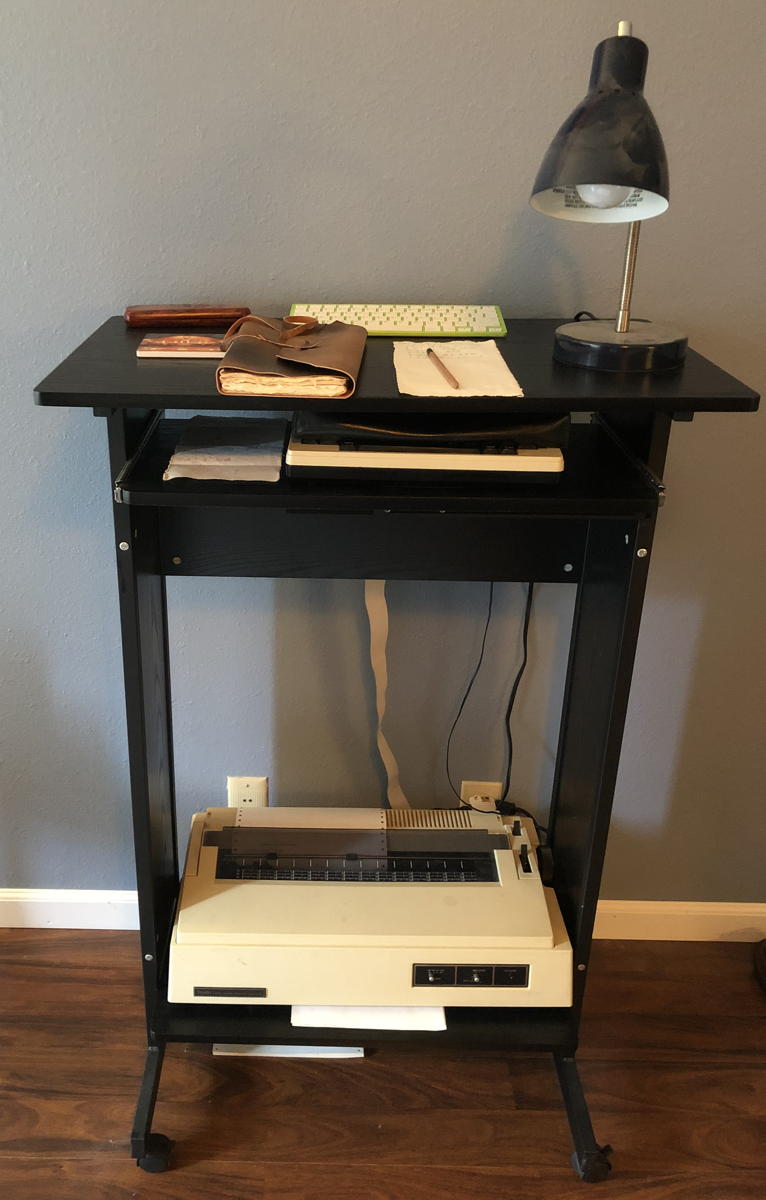 Model 100 workstation: A TRS-80 Model 100 and a Radio Shack DWP-230 printer on a stand-up workstation.; TRS-80 Model 100; Tandy DWP 230