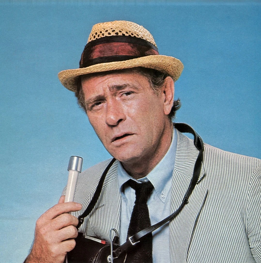 Carl Kolchak: Kolchak, holding a microphone and his signature portable tape recorder in Las Vegas.; Kolchak: The Night Stalker; Darren McGavin